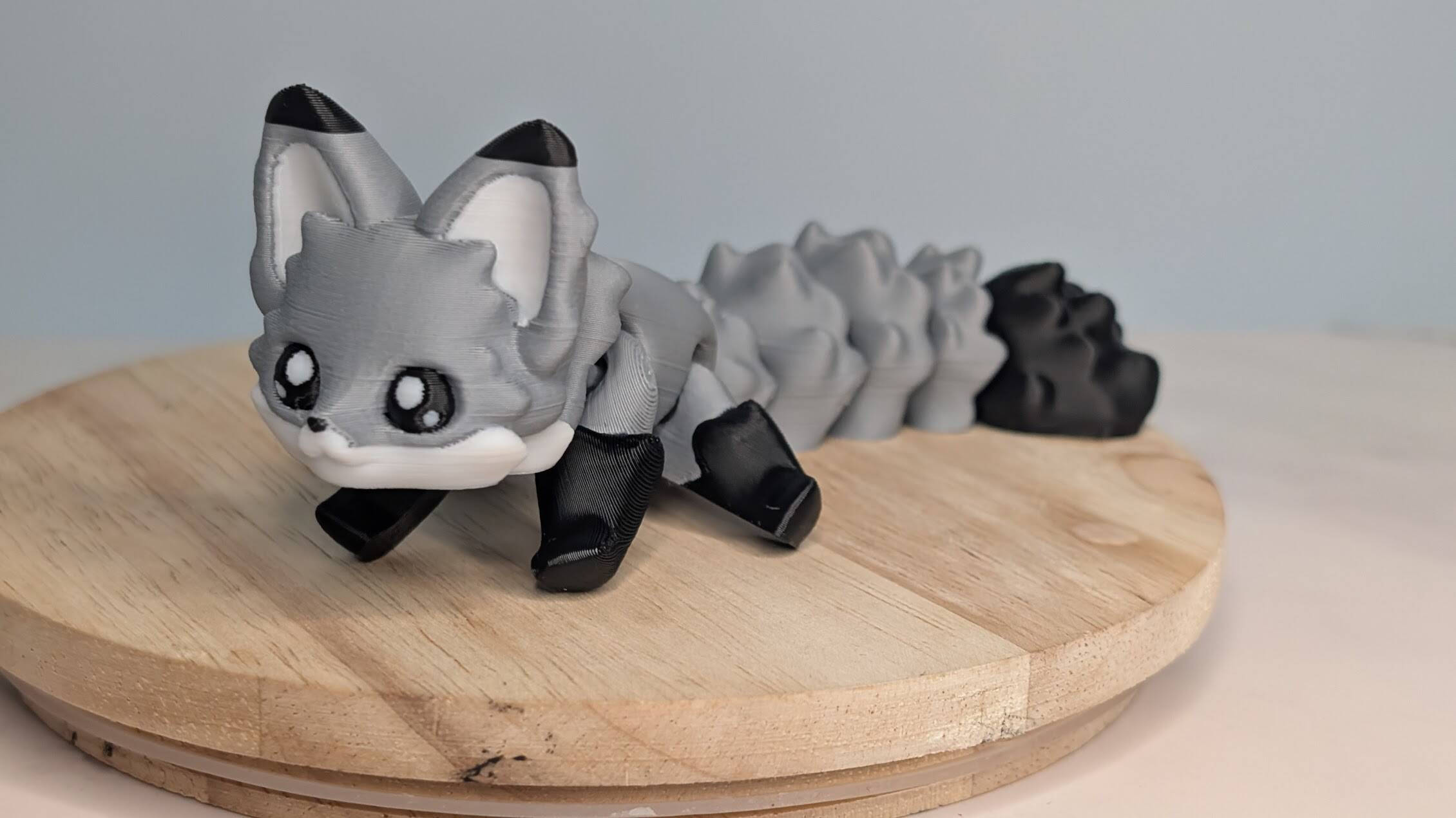 Gray and black articulated 3D-printed fox